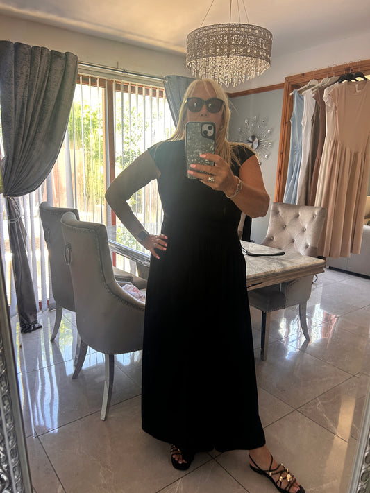 Person taking a mirror selfie in a room with furniture and decor.