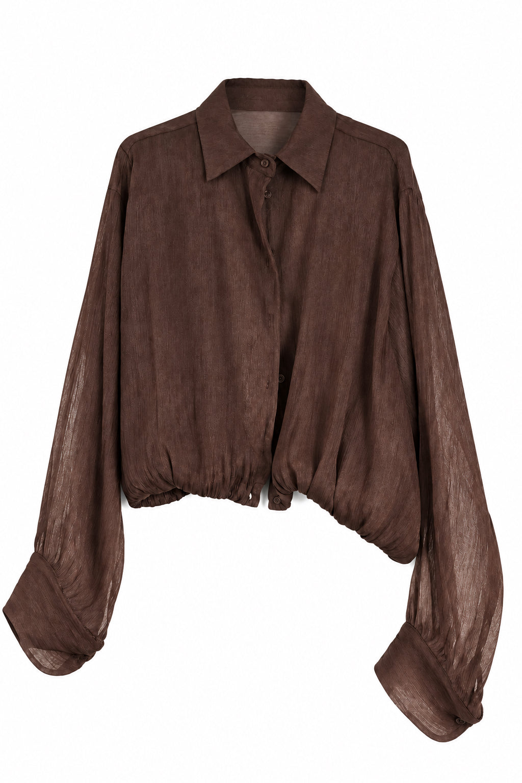 A dark brown long-sleeve button-up shirt with a relaxed, slightly sheer fabric, hanging on a white hanger against a white paneled wall.