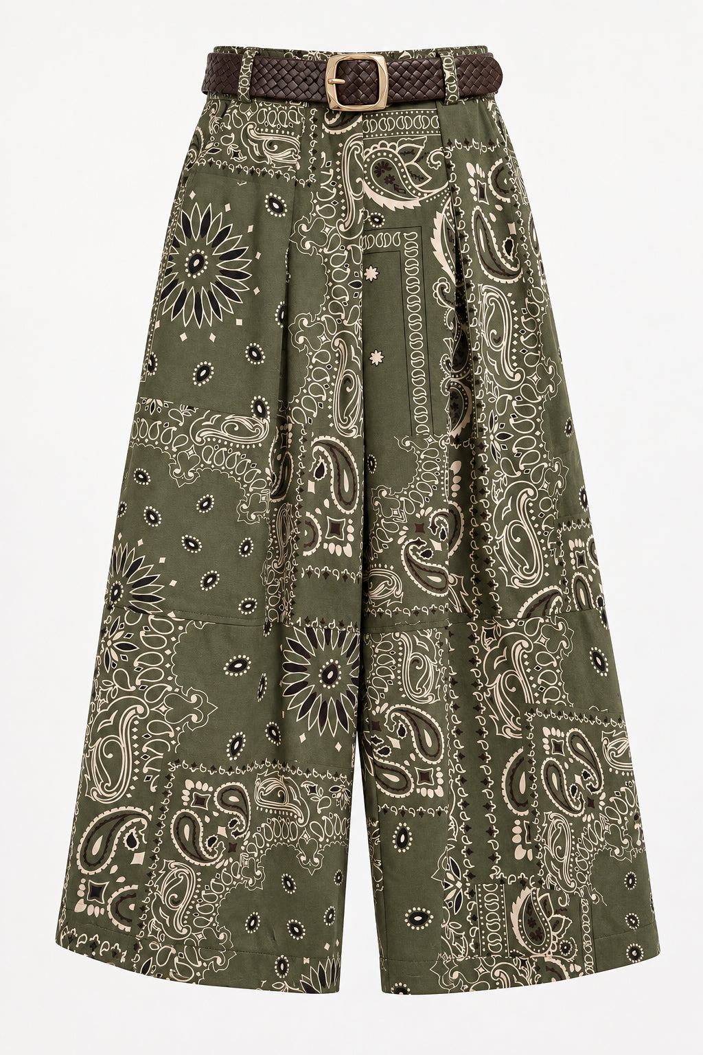 A pair of olive green patchwork bandana-print pants with a matching brown belt, hanging on a black hanger against a white paneled wall.