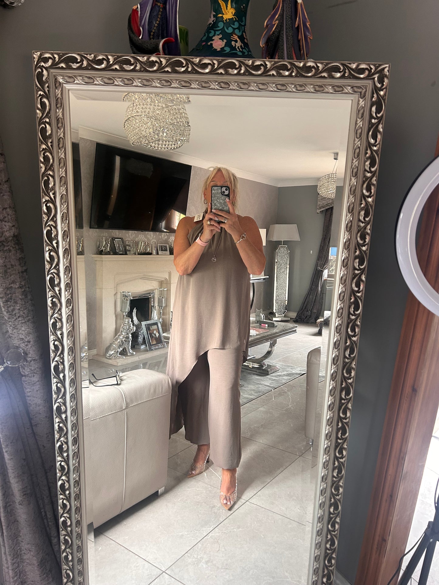  women wearing a taupe suit taking a selfie