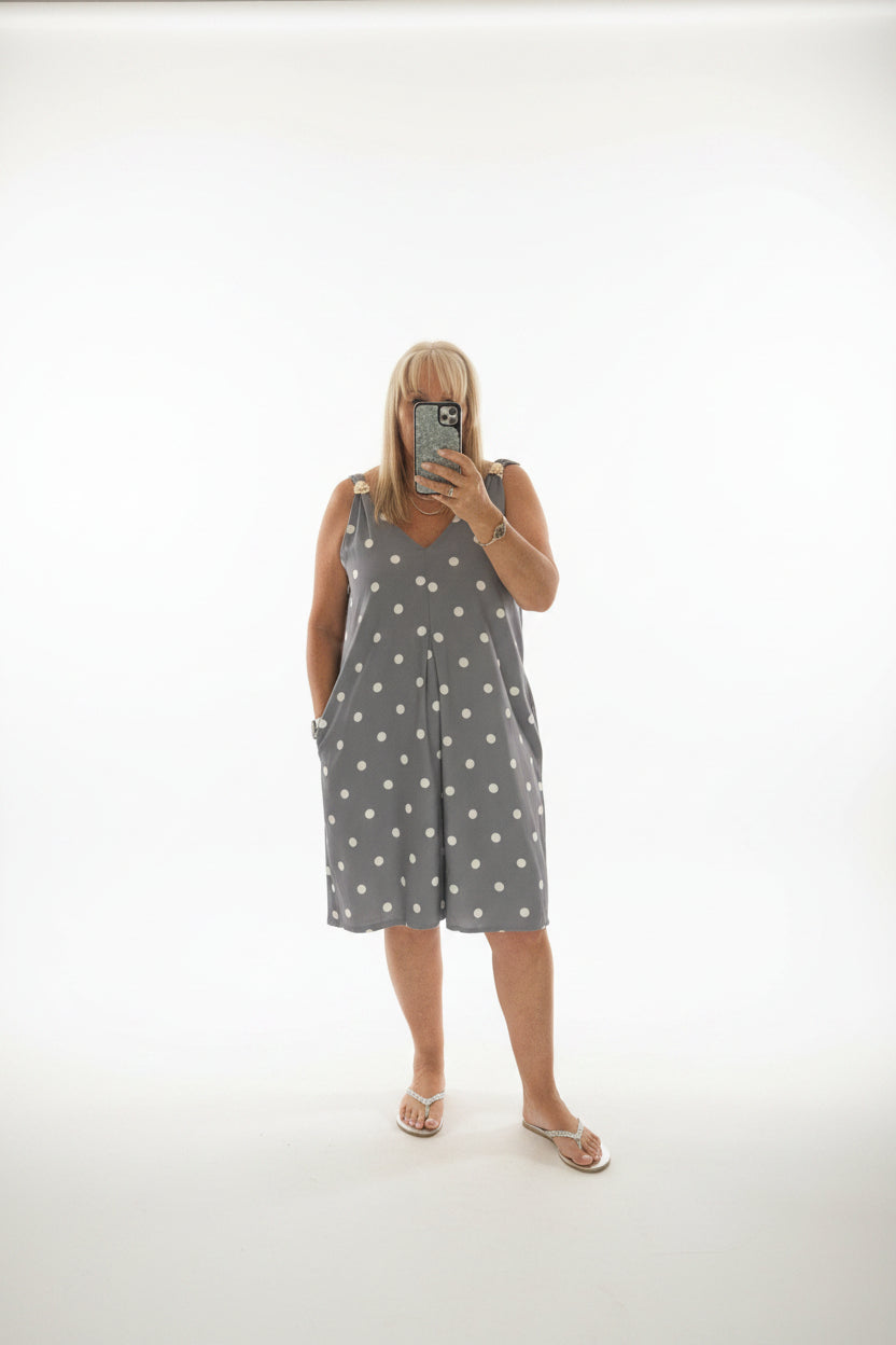 Person taking a mirror selfie in a room  wearing the dotty suit