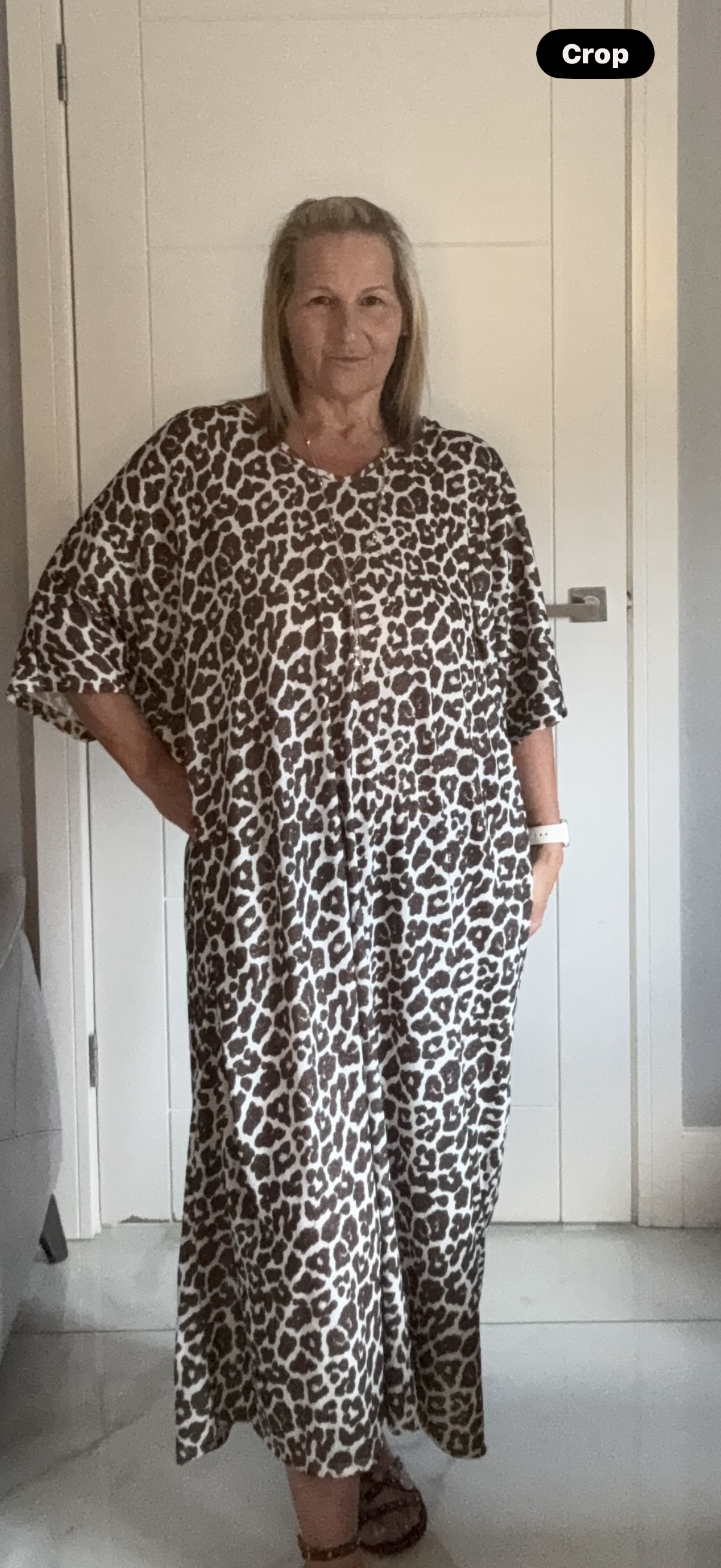 Woman wearing a leopard print dress with gold flecks and silk bow, one size fits 22-24"