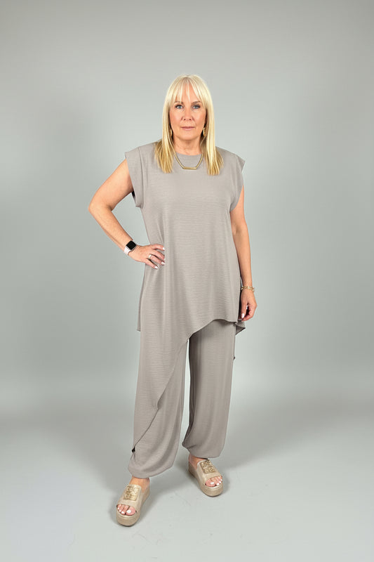 model wearing a taupe suit taking a selfie of the Tanya Asymmetrical coordinate
