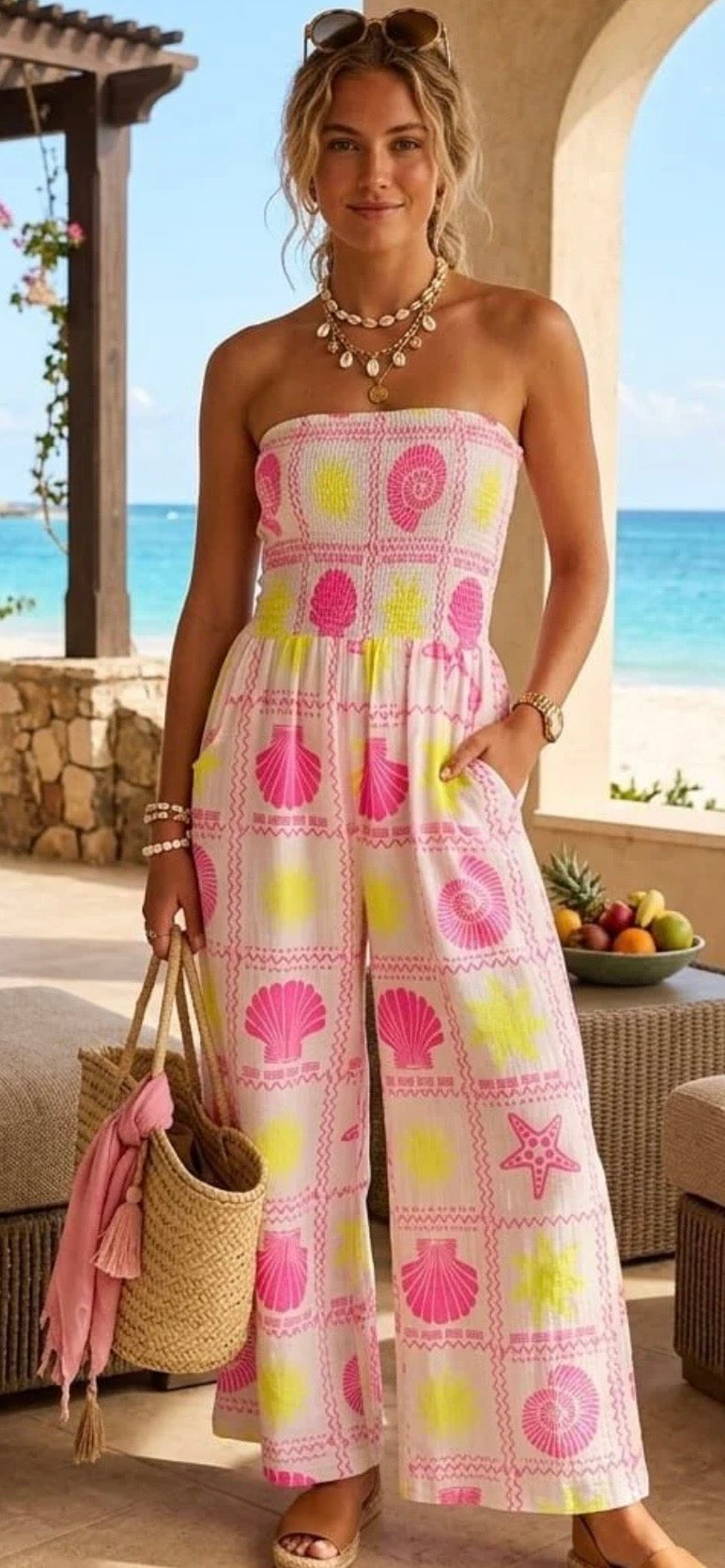 women wearing a coulouful jumpsuit by the ocean
