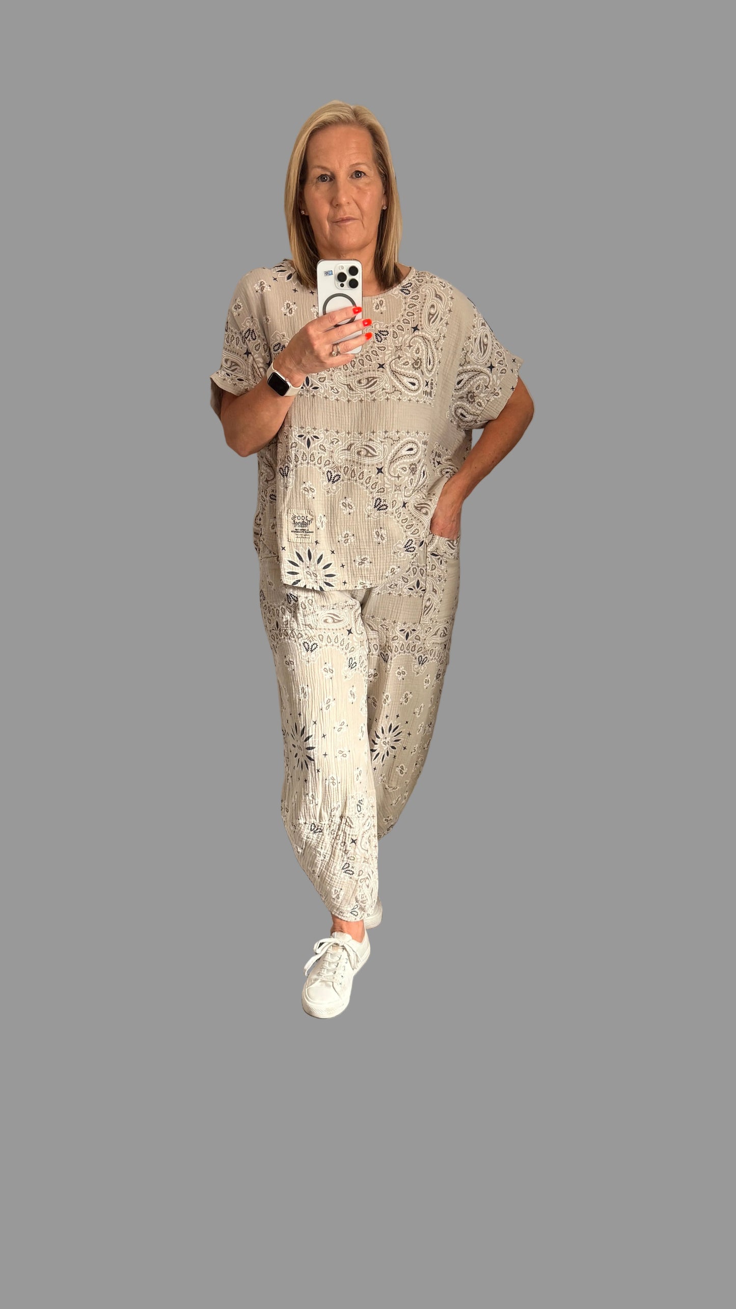 Woman wearing a Millie paisley outfit on a Gray background