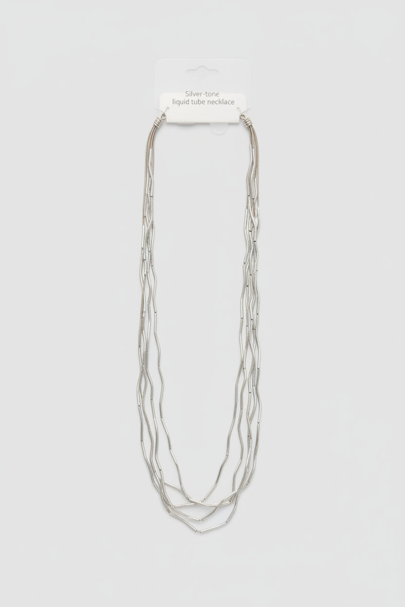 A long multi-strand silver chain necklace  with a white retail tag attached at the top.