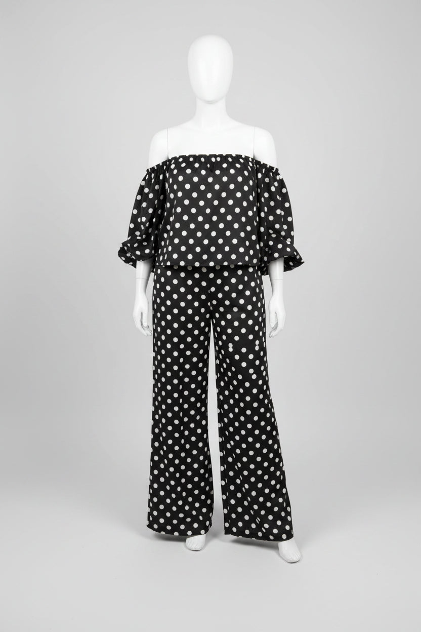 model taking selfie wearing a black polka dot suit