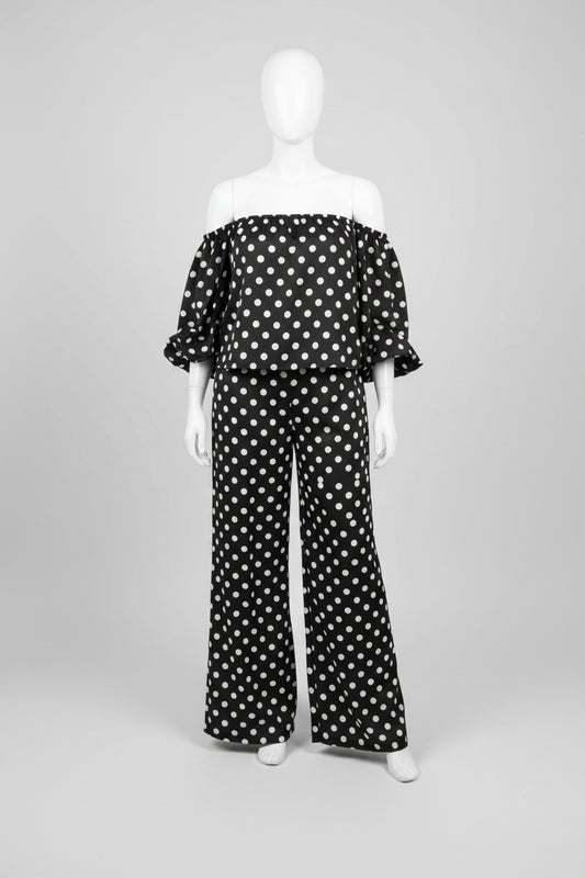 model taking selfie wearing a black polka dot suit