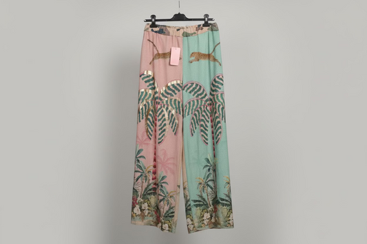 Two pairs of pants with animal and leaf patterns on a gray background