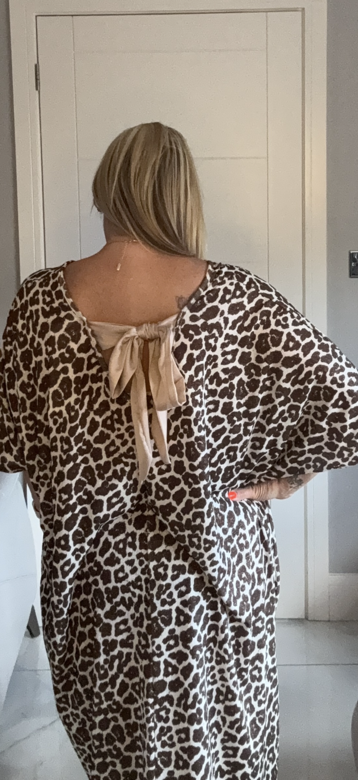 Leopard dress worn by women in a room with bow 