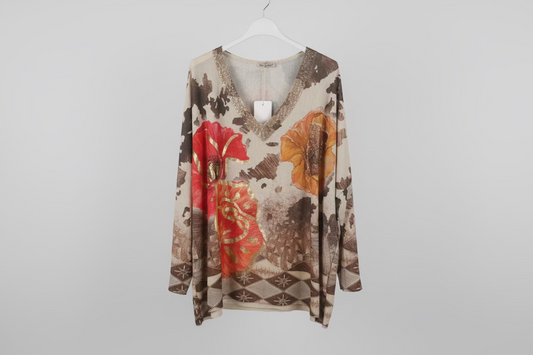 Floral patterned long-sleeve shirt on a hanger against a plain background