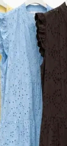 Two dresses, one blue and one brown, hanging side by side on a rack.