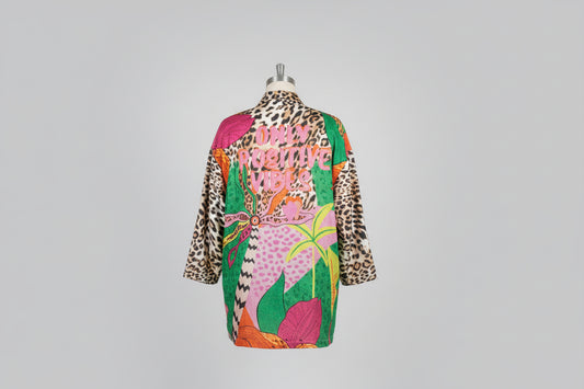 Colorful patterned dress on a mannequin against a gray background